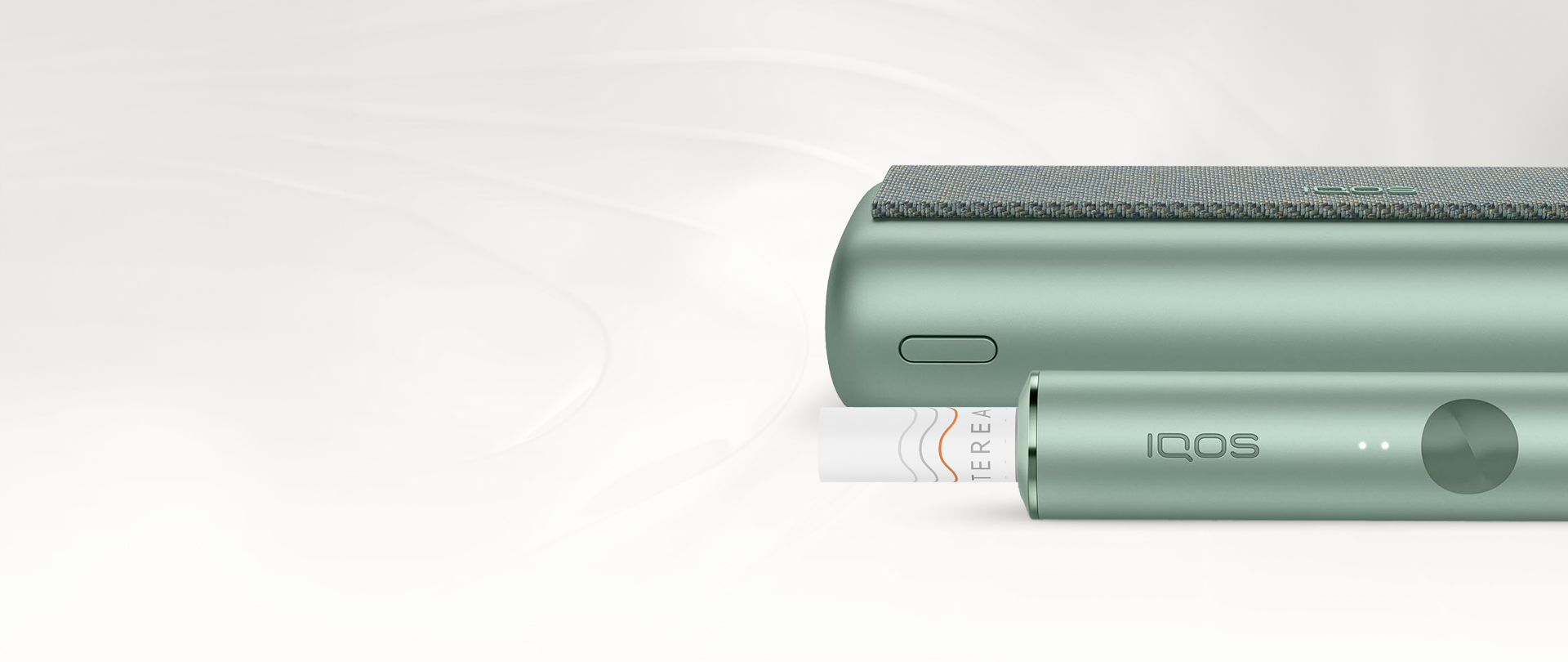 An IQOS ILUMA PRIME Holder with a TEREA stick inserted next to an IQOS ILUMA Pocket Charger.