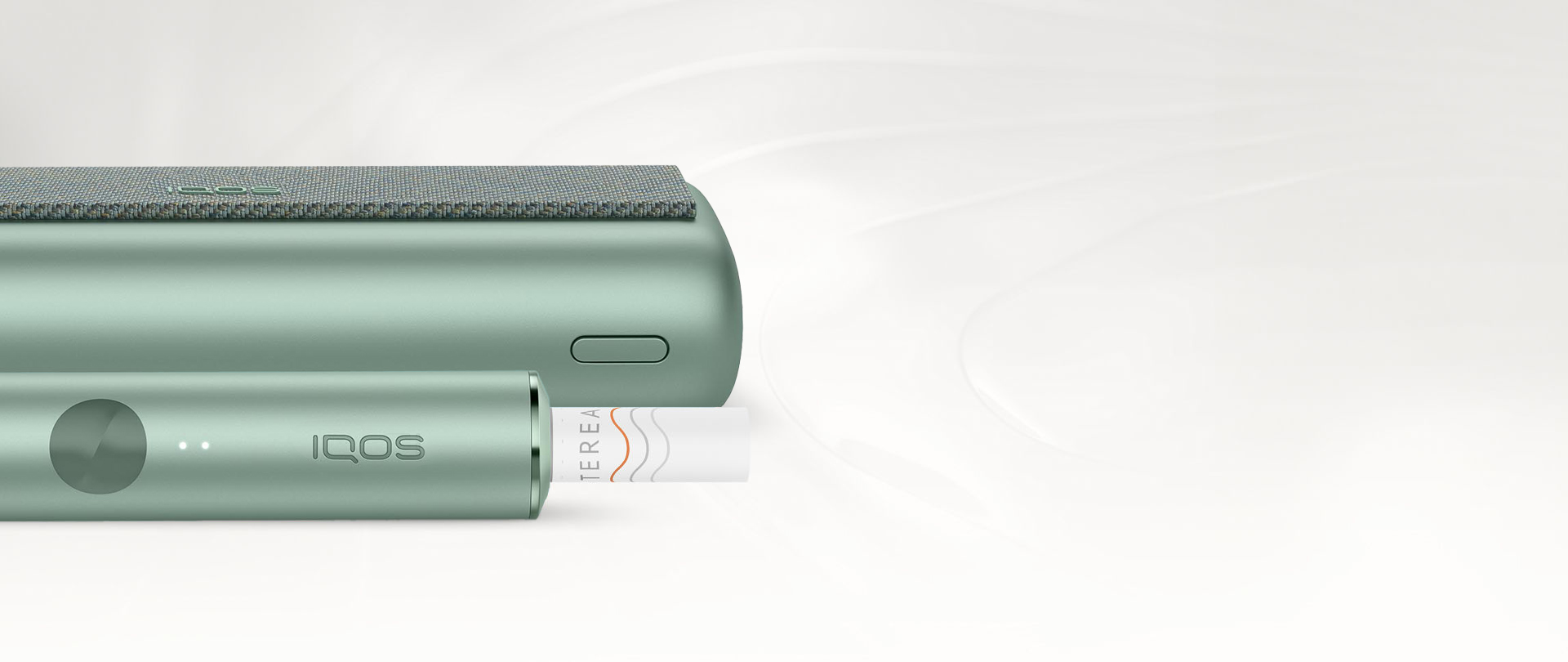 An IQOS ILUMA PRIME Holder with a TEREA stick inserted next to an IQOS ILUMA Pocket Charger.
