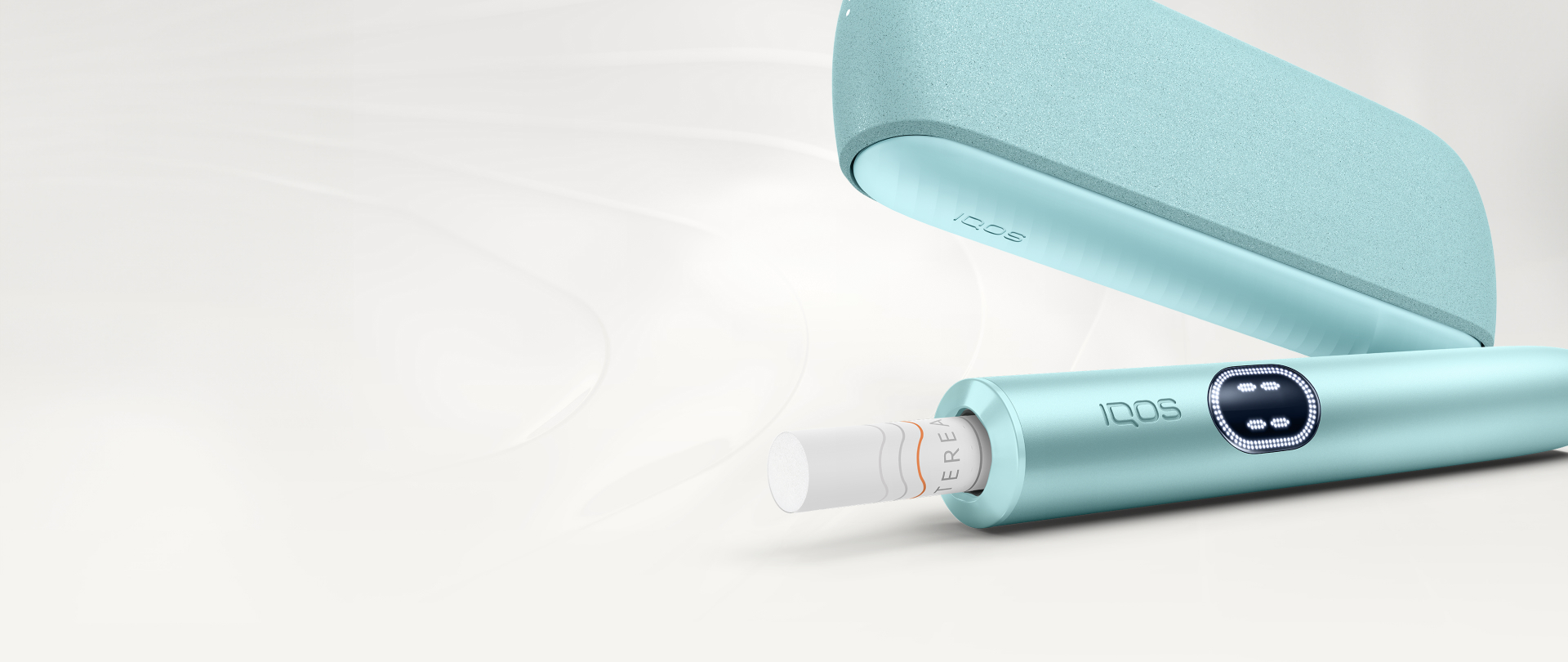 An IQOS ILUMA PRIME Holder with a TEREA stick inserted next to an IQOS ILUMA Pocket Charger.