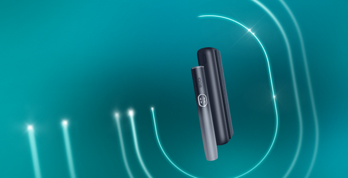 An IQOS ILUMA PRIME Holder with a TEREA stick inserted next to an IQOS ILUMA Pocket Charger.