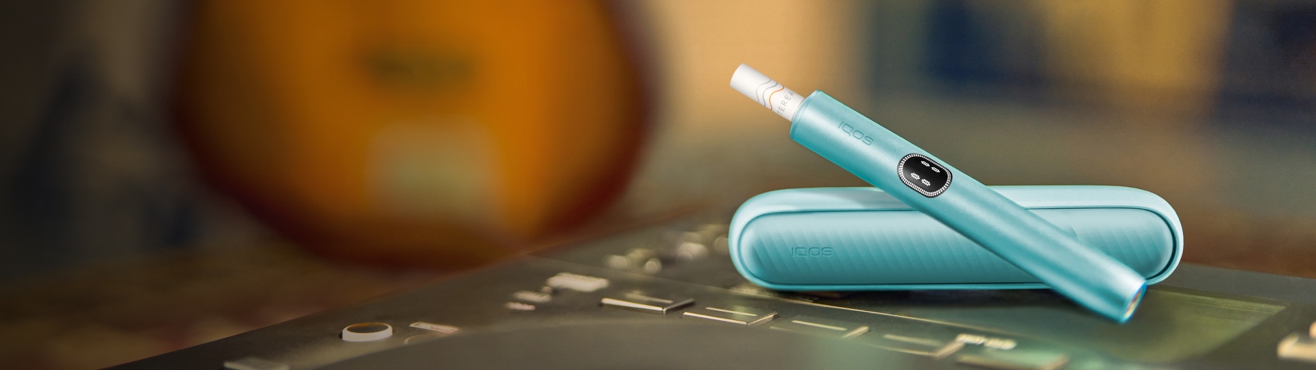 A Jade Green IQOS ILUMA PRIME Pocket Charger and Holder.