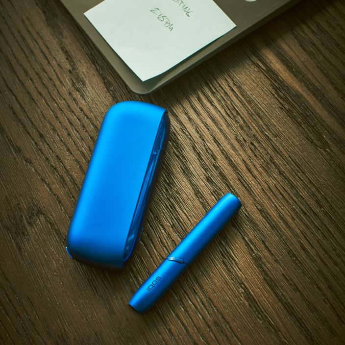 Blue IQOS 3 DUO on a wooden table