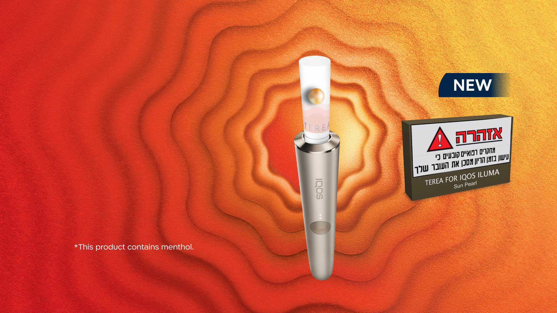 A gold IQOS device in a person's hand.