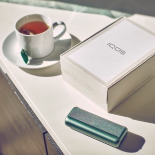 An IQOS box and IQOS ILUMA PRIME Pocket Charger.