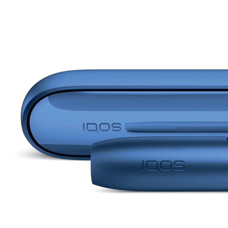 Cigarette filter with brown combustion stains compared to IQOS HEETS stick in IQOS 3 DUO holder with no equivalent stain.