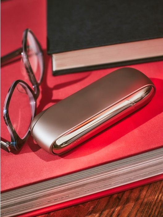 IQOS device, glassed, book