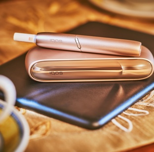 Woman on the street using an IQOS holder