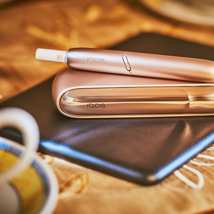 IQOS on gold background