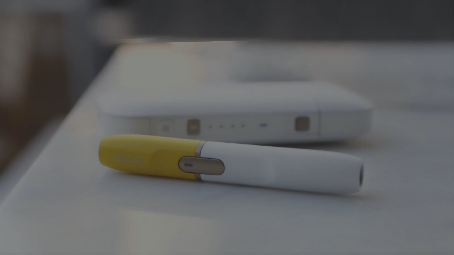 Gold IQOS Duo on a wooden table
