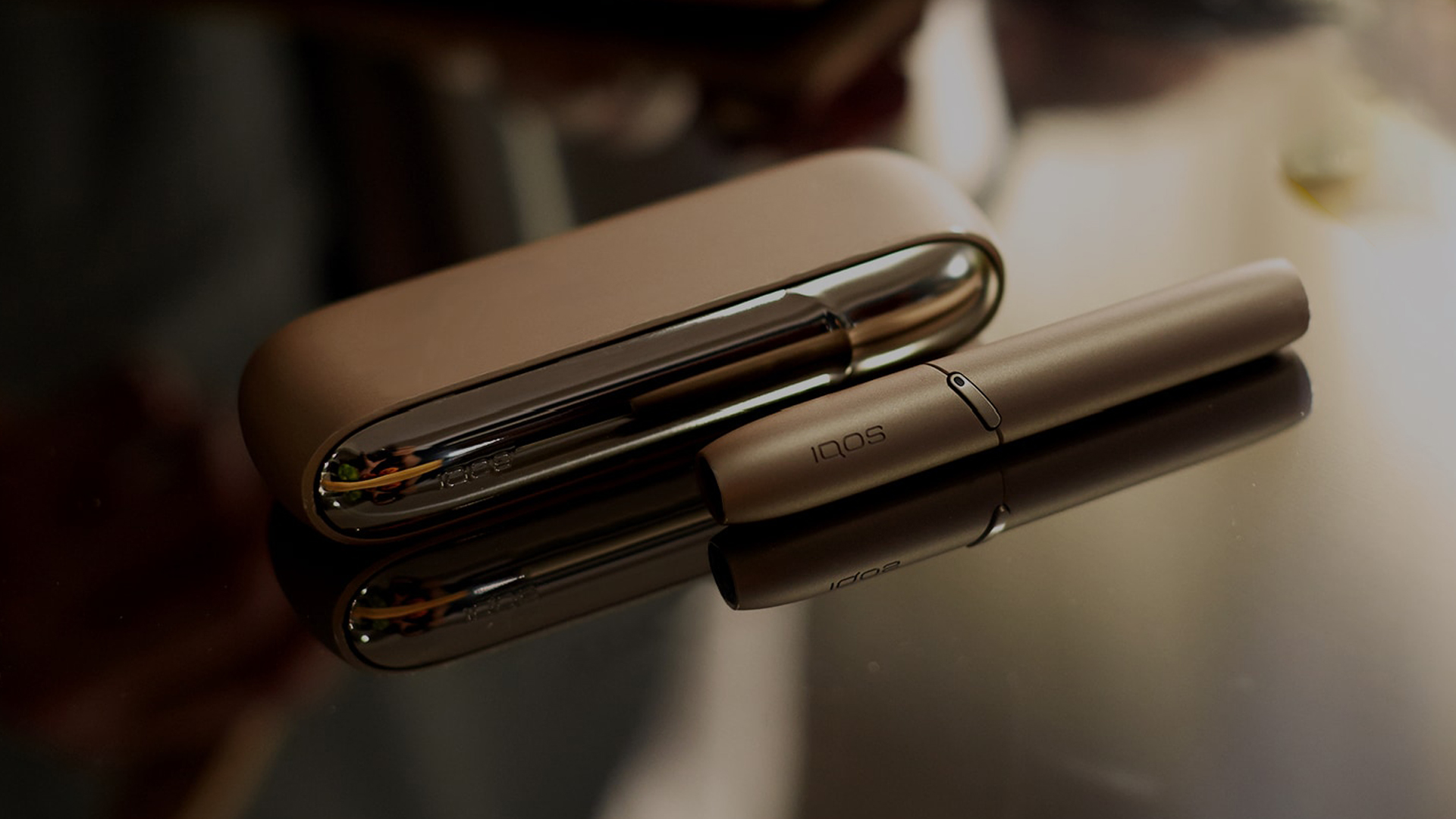 Gold IQOS Duo on a wooden table